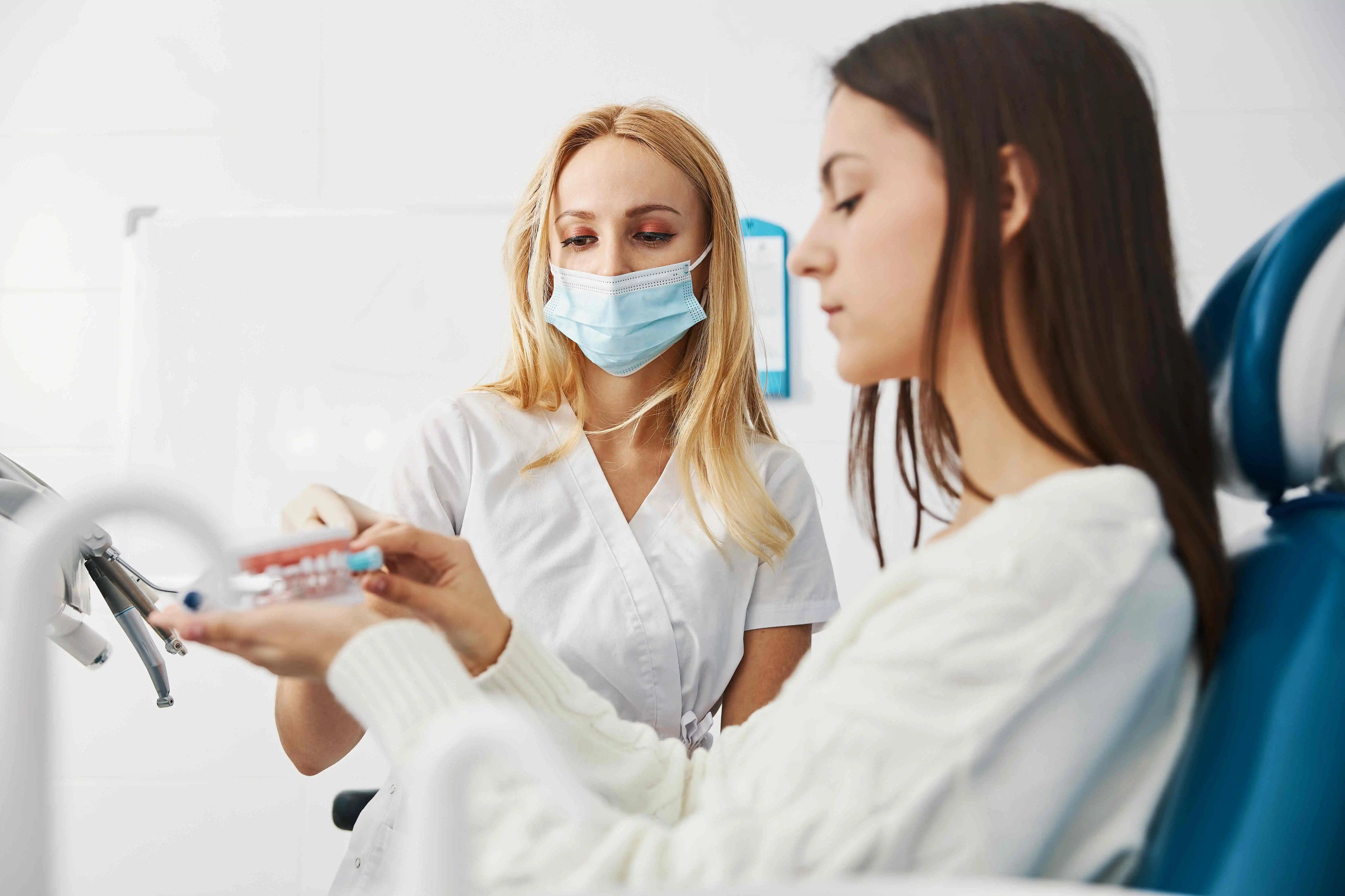 concentrated woman cleaning teeth Visit your dentist